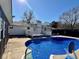 Lush backyard with an in-ground pool, a patio area, and a deck area for relaxing and enjoying outdoors at 4 Crestwood Rd, Cartersville, GA 30121