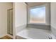 Bathroom featuring a soaking tub and window at 215 Eryn Ter, Covington, GA 30014