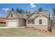 New single-story home with a two-car garage, landscaping, and a light beige exterior at 215 Eryn Ter, Covington, GA 30014