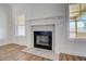 Living room fireplace with white mantel and tile surround at 215 Eryn Ter, Covington, GA 30014