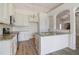 Kitchen boasts granite island, white cabinets, and hardwood floors at 215 Eryn Ter, Covington, GA 30014