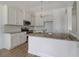 White kitchen cabinets, granite countertops, and stainless steel appliances at 215 Eryn Ter, Covington, GA 30014