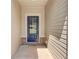 Side entrance with a blue door and brick base at 215 Eryn Ter, Covington, GA 30014