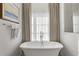 Relaxing bathroom with soaking tub, and large window at 803 Courtenay Ne Dr, Atlanta, GA 30306