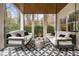 Covered patio with ceiling fan, swing beds, and patterned tile floor at 803 Courtenay Ne Dr, Atlanta, GA 30306