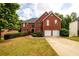 Brick house with two-car garage and manicured lawn at 1045 Paper Creek Dr, Lawrenceville, GA 30046