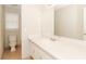 A clean bathroom with a white sink and cabinets as well as a toilet and shower with a window in background at 20 Oak Wood Ln, Covington, GA 30016