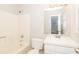 A well-lit bathroom featuring a bathtub, toilet, sink and a window that provides natural light at 20 Oak Wood Ln, Covington, GA 30016
