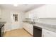 Bright kitchen features white cabinets, granite countertops, stainless steel appliances, and tile flooring at 20 Oak Wood Ln, Covington, GA 30016