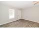 Inviting living room featuring modern gray floors, a bright window, and a freshly painted white door at 20 Oak Wood Ln, Covington, GA 30016