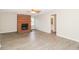 Spacious living room features gray floors, a brick fireplace, and an open doorway to the hall bathroom at 20 Oak Wood Ln, Covington, GA 30016
