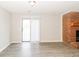 Bright living room features gray floors, brick fireplace, and a sliding door letting in natural light at 20 Oak Wood Ln, Covington, GA 30016