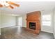 Cozy living area features gray flooring, a brick fireplace with mantle, and a sliding glass door at 20 Oak Wood Ln, Covington, GA 30016