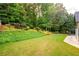Landscaped backyard, green grass, trees at 305 Mogie Ln, Acworth, GA 30102