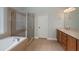 Bathroom boasts double vanity, soaking tub, and shower at 305 Mogie Ln, Acworth, GA 30102