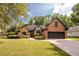 Brick home with stone accents, a landscaped lawn, and a two-car garage at 305 Mogie Ln, Acworth, GA 30102