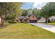 Brick ranch house with a landscaped lawn and two-car garage at 305 Mogie Ln, Acworth, GA 30102