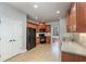 Modern kitchen with wood cabinets, black appliances, and tile floors at 305 Mogie Ln, Acworth, GA 30102