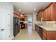 Modern kitchen with wood cabinets, black appliances, and tile floors at 305 Mogie Ln, Acworth, GA 30102