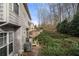 View of the side of the townhome in the backyard with patio area and beautiful landscaping at 5800 Oakdale Se Rd # 165, Mableton, GA 30126