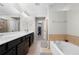 Bright bathroom with dual sinks, soaking tub, and a glass enclosed shower offer a spa-like experience at 5800 Oakdale Se Rd # 165, Mableton, GA 30126