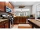 Charming kitchen with stainless appliances, granite countertops, and dark wood cabinetry at 5800 Oakdale Se Rd # 165, Mableton, GA 30126