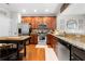 Well-equipped kitchen with stainless steel appliances, granite countertops, wooden cabinets, and a cozy breakfast area at 5800 Oakdale Se Rd # 165, Mableton, GA 30126