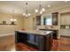 Island kitchen with granite countertops and dark wood cabinets at 2005 Heathermere Way, Roswell, GA 30075