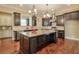 Open kitchen with large island, granite countertops, and stainless steel appliances at 2005 Heathermere Way, Roswell, GA 30075