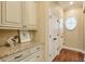 Laundry room with granite countertop, built-in cabinets and drawers at 2005 Heathermere Way, Roswell, GA 30075