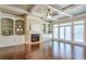Living room with hardwood floors, fireplace, and built-in shelving and large windows at 2005 Heathermere Way, Roswell, GA 30075
