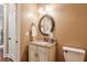 Small powder room with granite vanity and oval mirror at 2005 Heathermere Way, Roswell, GA 30075