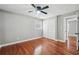 Bright bedroom with hardwood floors, ceiling fan and double door closet at 871 Harwell Nw Rd, Atlanta, GA 30318