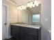 Double vanity bathroom with granite countertops and large mirror at 130 Eryn Ter, Covington, GA 30014