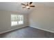 Spacious bedroom with ceiling fan and large window at 130 Eryn Ter, Covington, GA 30014