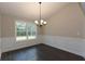 Bright dining room with wainscoting and chandelier at 130 Eryn Ter, Covington, GA 30014