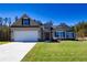 Two-story craftsman style home with attached garage and manicured lawn at 130 Eryn Ter, Covington, GA 30014