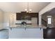 Kitchen island with granite countertop and dark cabinets at 130 Eryn Ter, Covington, GA 30014