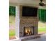 Brick outdoor fireplace with built-in TV, perfect for entertaining at 130 Eryn Ter, Covington, GA 30014