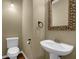 Powder room features a pedestal sink and decorative seashell mirror at 2935 Maple Park Pl # 49, Cumming, GA 30041
