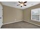 Bedroom features a ceiling fan and natural lighting from a window at 2935 Maple Park Pl # 49, Cumming, GA 30041