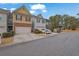 Townhome exteriors showing attached garages, manicured bushes, and street view at 2935 Maple Park Pl # 49, Cumming, GA 30041