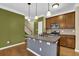 Well-equipped kitchen features island with counter seating, stainless steel appliances, and wooden cabinets at 2935 Maple Park Pl # 49, Cumming, GA 30041