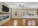 Bright living room features fireplace, ceiling fan, and backyard access at 2935 Maple Park Pl # 49, Cumming, GA 30041