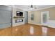 Bright living room with fireplace, hardwood floors, ceiling fan, and backyard access at 2935 Maple Park Pl # 49, Cumming, GA 30041