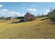 Large backyard offering space and potential, with the home featuring brick accents at 328 Thistlewood Run, Mcdonough, GA 30252