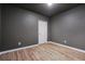 Basement bedroom featuring laminate flooring, neutral walls, and a door to a hallway at 328 Thistlewood Run, Mcdonough, GA 30252