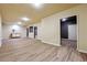 Open basement with laminate flooring, recessed lights, a sink and access to another room at 328 Thistlewood Run, Mcdonough, GA 30252