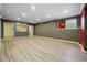 Finished basement with laminate flooring, recessed lighting, and access to another room at 328 Thistlewood Run, Mcdonough, GA 30252