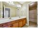 Bathroom featuring double sinks with a large mirror and tile flooring at 328 Thistlewood Run, Mcdonough, GA 30252